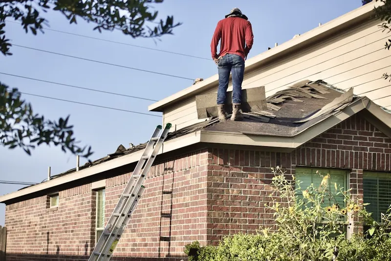 Professional roofer working on a residential roof in Big Woods Acres